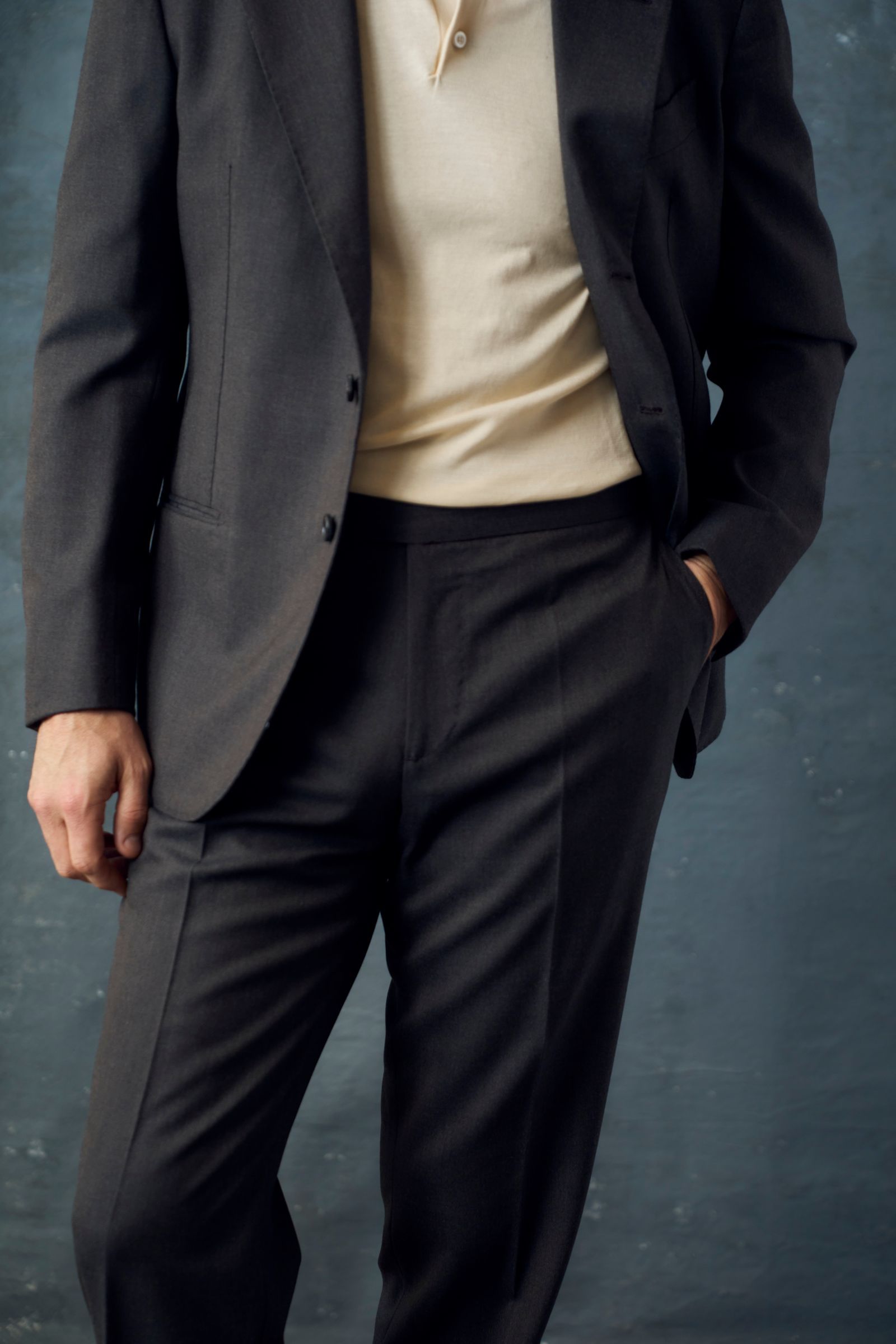 Image may contain Blazer Clothing Coat Formal Wear Jacket Suit Pants Tuxedo Adult and Person